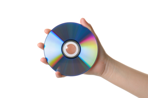 Chinese female hand holding a Compact Disk isolated on white with clipping path.