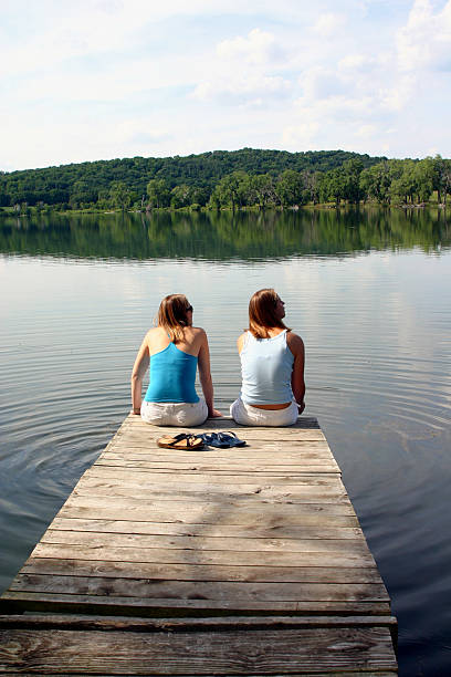 istock Girls on the Dock overlooking Lake 183262471
