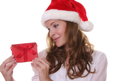 Close-up image of a young beautiful lady making a x-mas wish on the foreground
