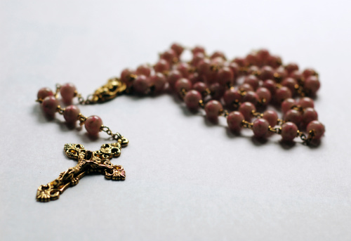 Close-up view of rosary. Focus on cross.