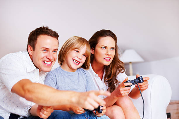istock Playful middle aged couple with their son playing video game 183263683