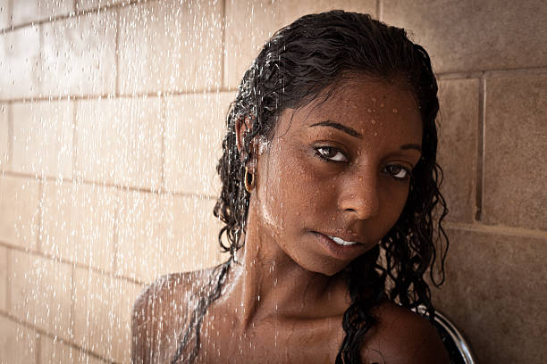 Pretty Puerto Rican woman stands in a shower stock photo