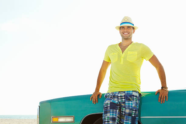 istock Happy young man leaning on his Cadillac car - copyspace 183264681
