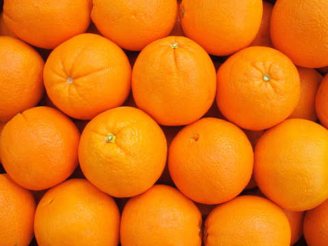 Case of navel oranges arranged neatly in market