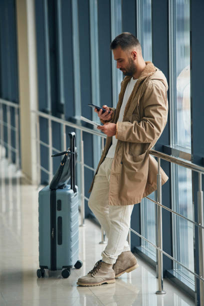 istock Waiting, standing inside. Young handsome man in the airport 1832661930