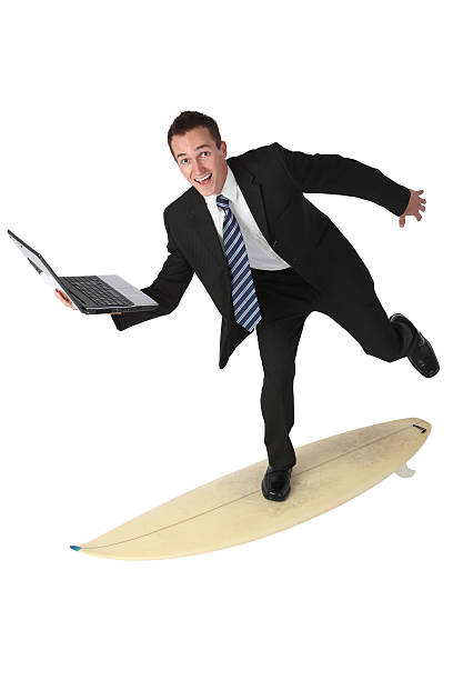 istock Businessman surfing on surfboard and carrying a laptop 183266200