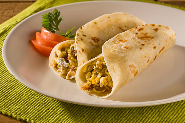 This image features an exciting array of assorted tacos stuffed with delicious ingredients, served with two rich salsas, perfect for a vibrant and flavorful meal.