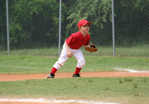 a boy in the field in a baseball game