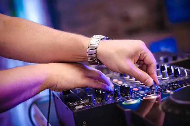 a close-up of dj hands at work. Photo shouted on party.