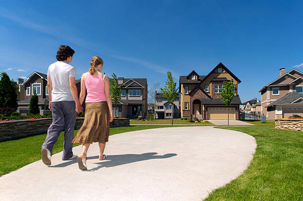 istock Young couple holding hands and walking down the side walk 183267060