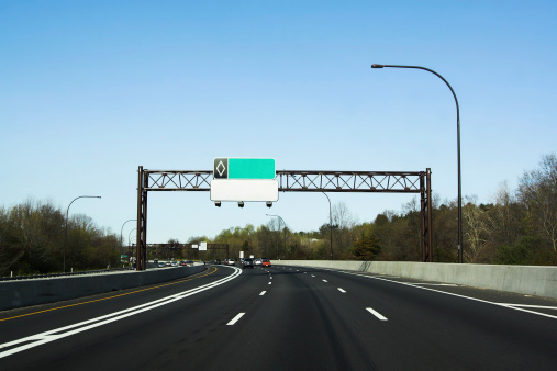 NY, USA-May 2022; View over highway with overhead road signs at exit 2 in the direction of New York City and Albany over the Saw Mill River Parkway