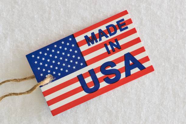 made in usa label sitting on top of white clothing as a business economics concept. - buy usa american culture made in the usa imagens e fotografias de stock