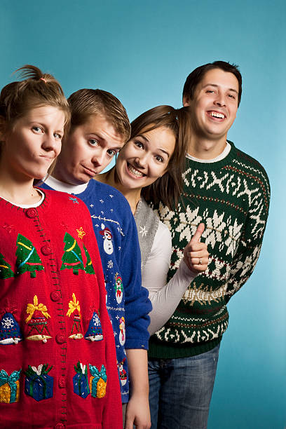 Ugly Sweater Group Happy A group of young adults in ugly Christmas sweaters christmas nerd sweater cardigan stock pictures, royalty-free photos & images