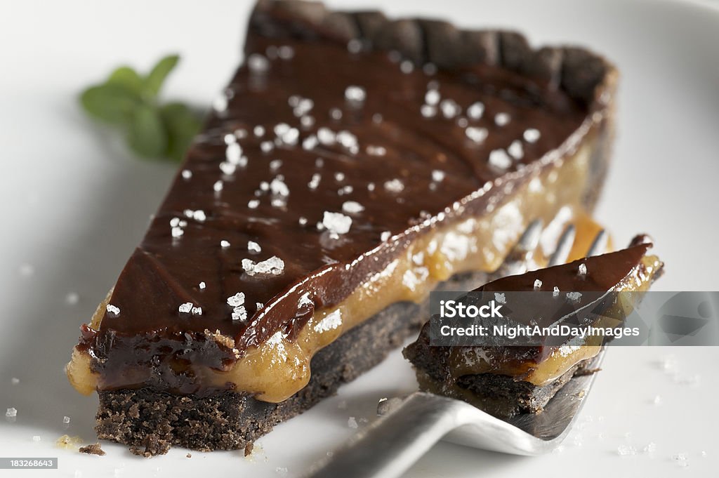 Chocolate Caramel Tart with Sea Salt "Close up of a chocolate tart shell filled with caramel, topped with dark chocolate ganache and sprinkled with fleur de sel, a French artisanal sea salt.  Very shallow DOF." Salt - Seasoning Stock Photo