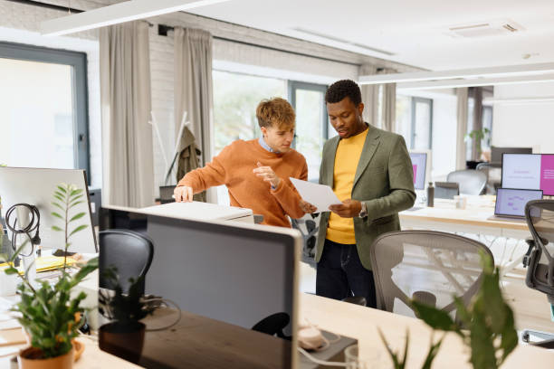 istock Two colleagues talking about something in the modern office space 1832695229