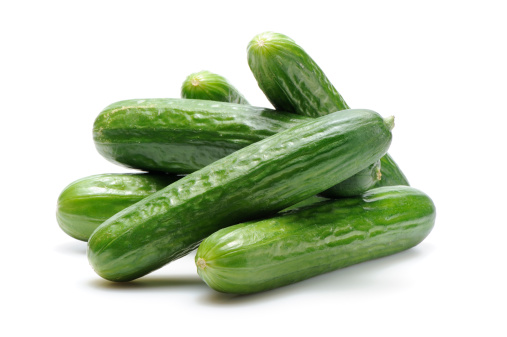 Stack of cucumbers isolated on white