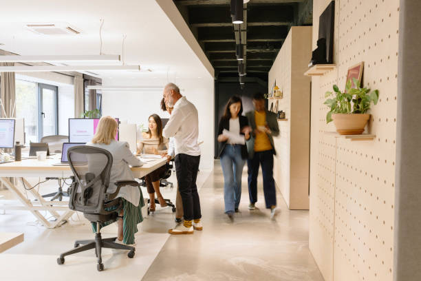 istock Team of colleagues talking about something in the modern working space 1832698981