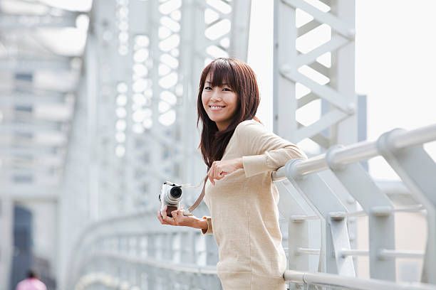 Woman who smiles having a camera stock photo