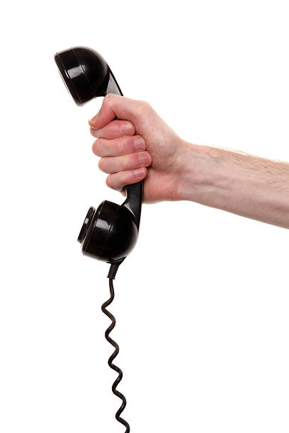 istock Black, retro phone receiver in hand against white background 183270130