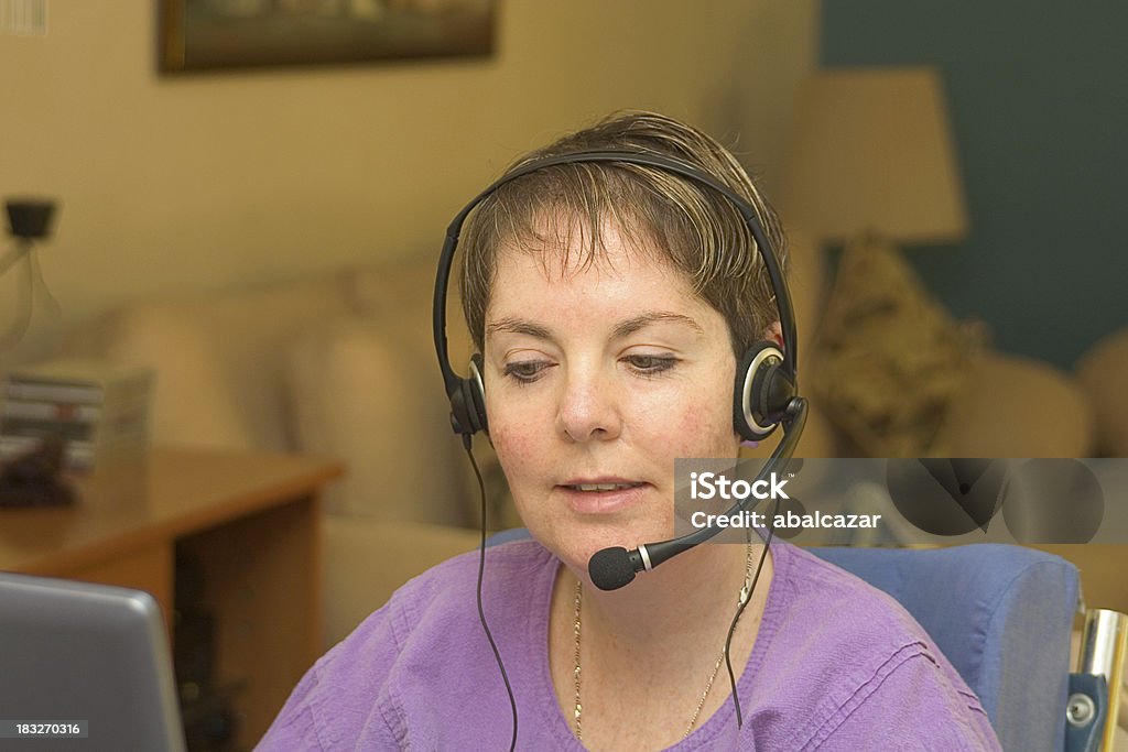 working from home "disabled woman working from home, in her living room making calls" Customer Service Representative Stock Photo