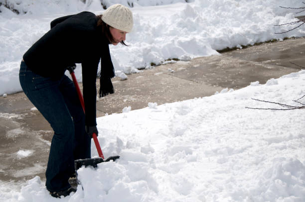 istock Woman Clearing Snow from Driveway 183270624