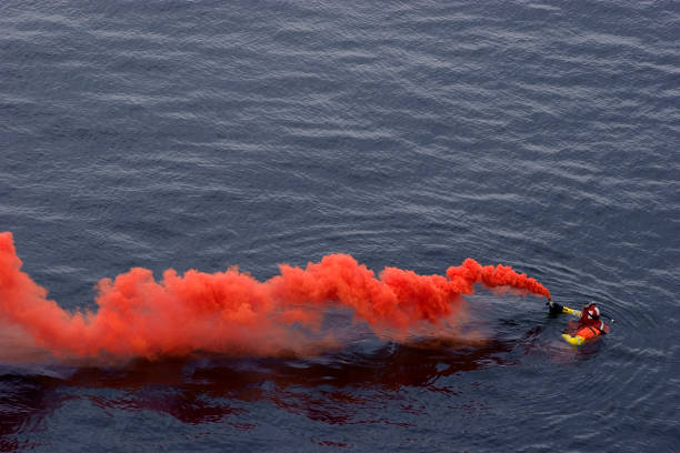 Save Me! Person with Rescue Smoke flare, awaiting rescue. signal flare stock pictures, royalty-free photos & images