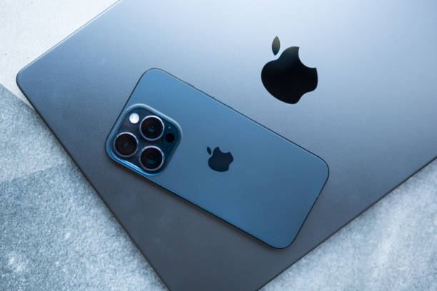 Bangkok, Thailand - December 5, 2023 : Newly released a iPhone 15 pro max blue titanium and Apple MacBook Pro M3 Max space black laptop in 2023. Top view