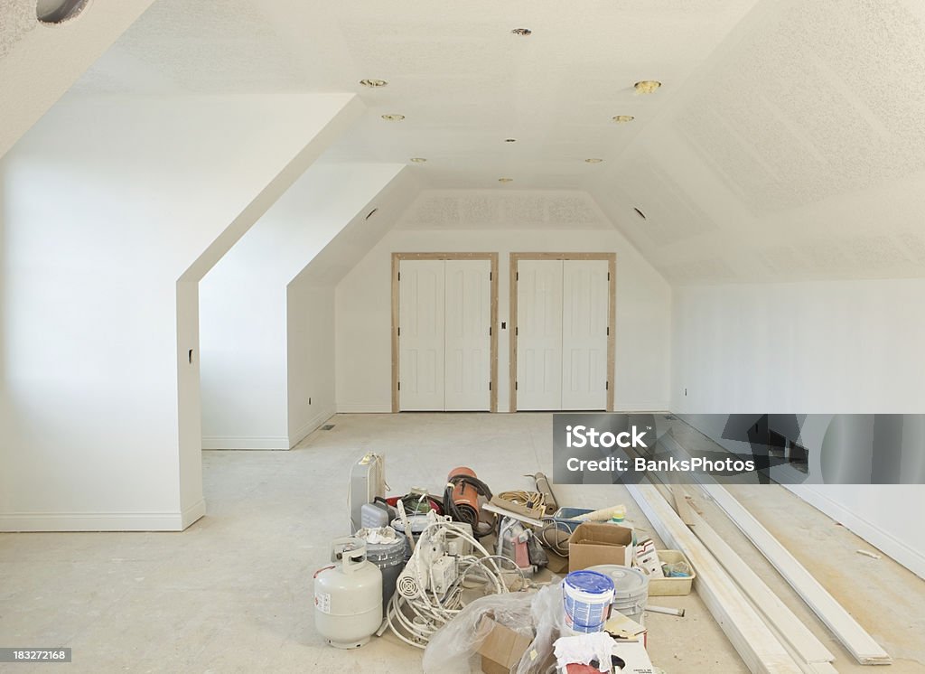 New Primed Room at Residential Construction Site "A new bonus room, with complex angles, at a residential construction site with primed wall and ceiling. Painteraas supplies and equipment rest on the floor.A related image from my portfolio:" Drywall Stock Photo