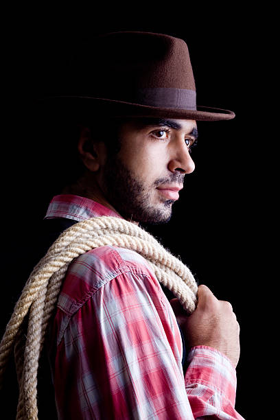 istock Handsome cowboy holding rope and smoking cigar 183272692