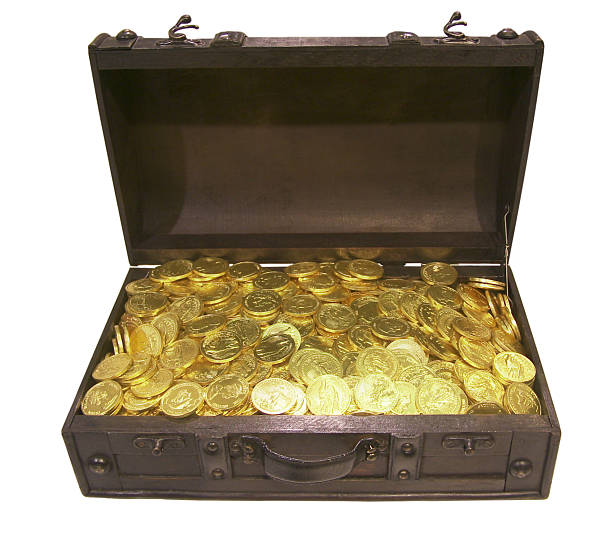 Treasure chest filled with golden gold coins of Queen Elizabeth stock photo