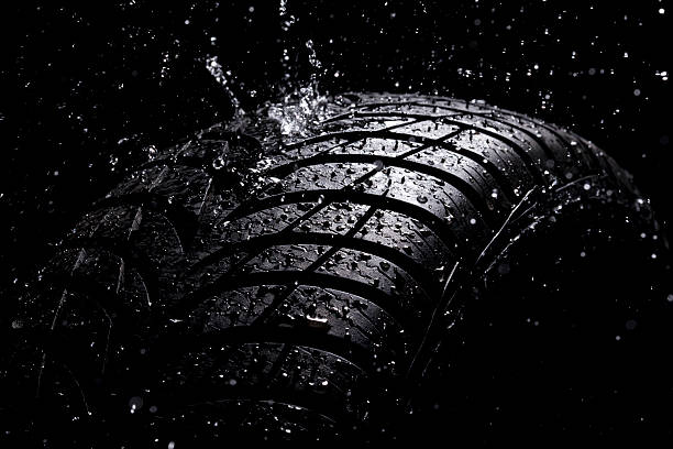Water splashing on a new tire during the rain stock photo