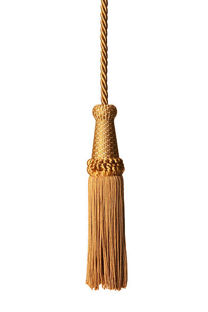 Gold isolated tassel Isolated gold tassel on white. tassel stock pictures, royalty-free photos & images