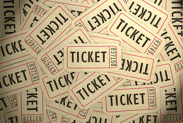 A pile of several white, black and red ticket stubs stock photo