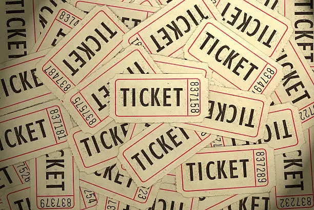 Photo of A pile of several white, black and red ticket stubs