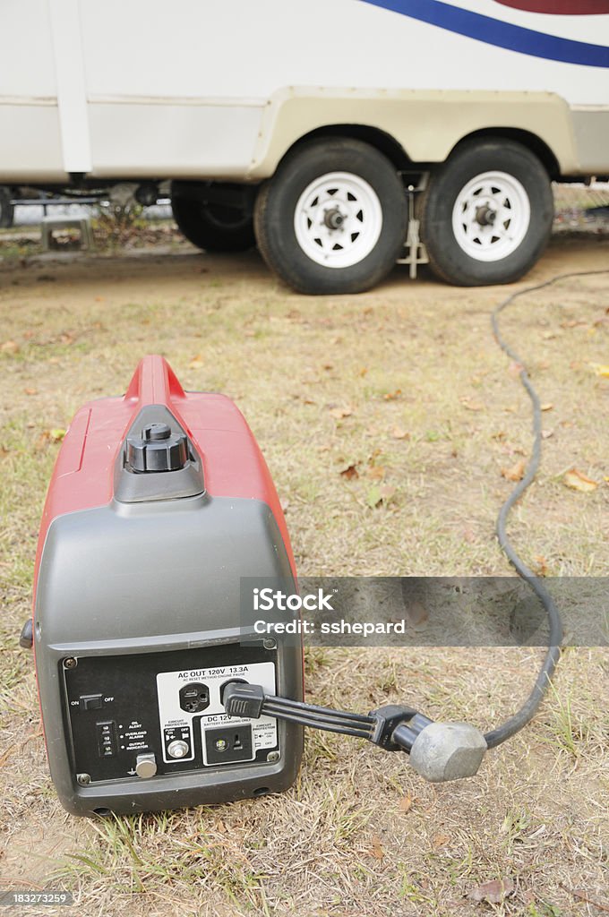 Generator connected to rv trailer "Portable gasoline generator connected to rv travel trailer via power cord, horizontal" Generator Stock Photo