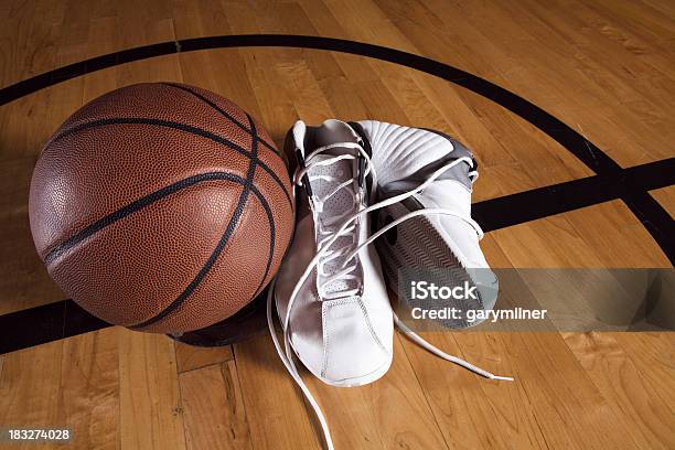 Pair Of White Basketball Shoes Next To Basketball On Court Stock Photo - Download Image Now