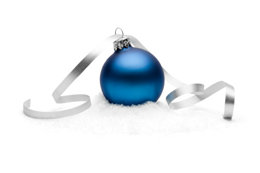 Photograph of a blue christmas bauble on snow.More like this: