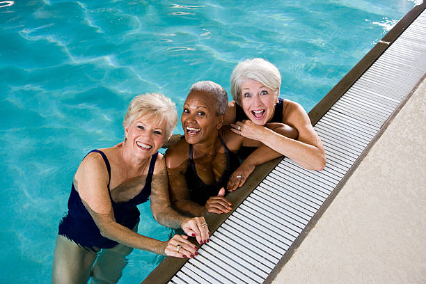 istock Active senior women, friends at swimming pool 183274081