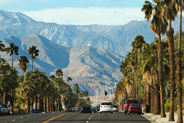 View along highway to mountains, Palm Springs, California A scenic road in Palm Springs, California. palm springs california stock pictures, royalty-free photos & images