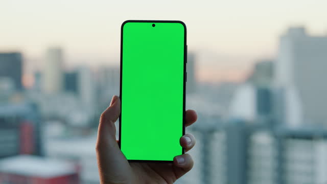 Closeup, hand and phone with green screen for homepage, website or social media mockup. Person, hold and technology for contact us, faq or about us on mobile app, for information, promotion or offer