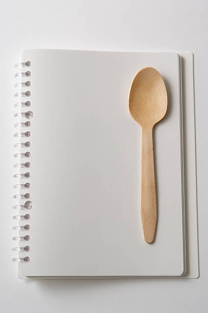 istock Blank spiral notebook with wooden spoon on white background 183274706