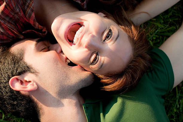 istock Couple kissing, laying on meadow 183275482