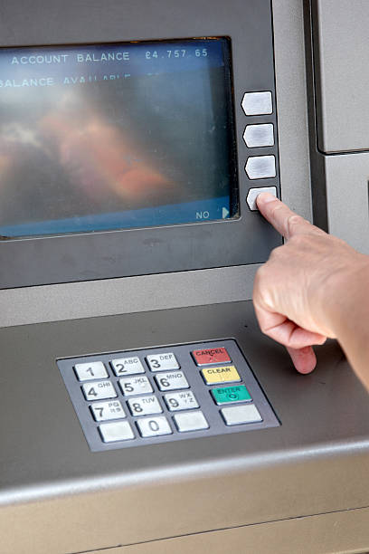 istock Woman making ATM withdrawal 183275611