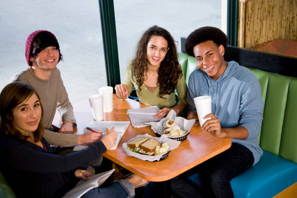 istock Multi-ethnic teenagers having lunch together in restaurant 183275693
