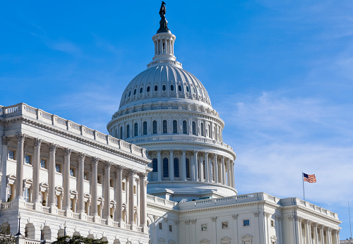 West facade of the United States Capitol in the early morning.