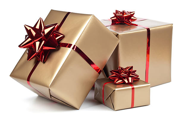 Gift boxes Gold gift boxes with red ribbon on white. This file contains christmas present stock pictures, royalty-free photos & images