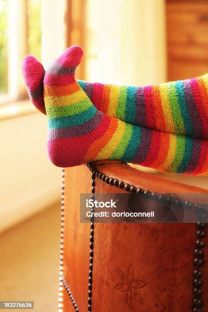 Feet Of A Person Wearing Rainbow Socks While Resting Stock Photo - Download Image Now