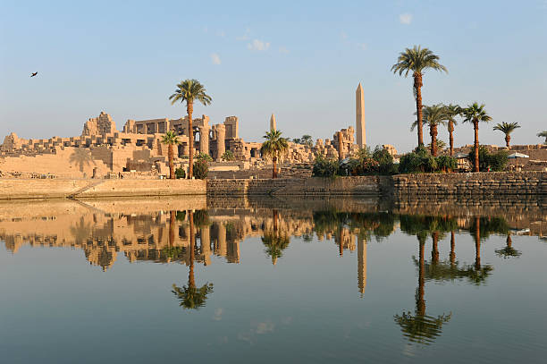 Karnak temple at dawn "The Ancient Egyptian temple of Karnak illuminated by and reflecting the golden light of early morningLuxor, Egypt" luxor thebes photos stock pictures, royalty-free photos & images