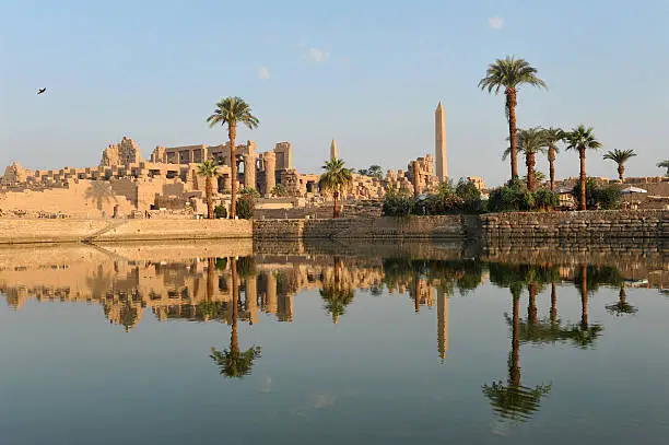 "The Ancient Egyptian temple of Karnak illuminated by and reflecting the golden light of early morningLuxor, Egypt"