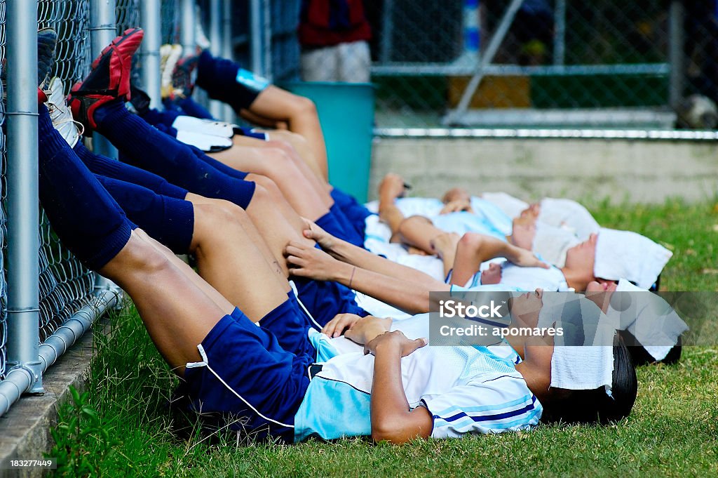 Team of soccer girls resting in the break After a tough game female soccer players take a rest getting ready for 2nd half of the game Sleeping Stock Photo